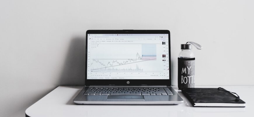 a laptop computer sitting on top of a white desk