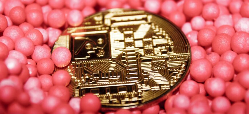 a close up of a coin surrounded by pink balls